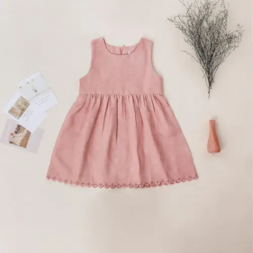  An elegant pink dress with lace detailing and floral accents, embodying a graceful and feminine aesthetic.